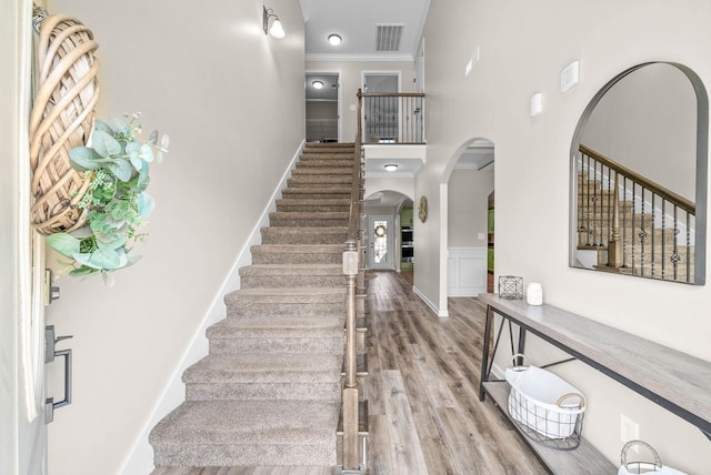 185 Kildeer Dr, Clarksville, TN 37040 - stairway featuring arched walkways, ornamental molding, visible vents, and wood finished floors