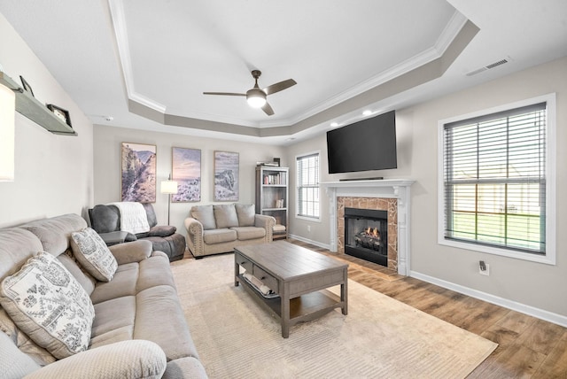 185 Kildeer Dr, Clarksville, TN 37040 - living room featuring a tray ceiling, baseboards, light wood finished floors, ceiling fan, and visible vents