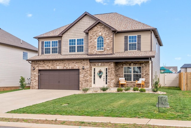 185 Kildeer Dr, Clarksville, TN 37040 - craftsman-style home with concrete driveway, fence, an attached garage, brick siding, and a front lawn