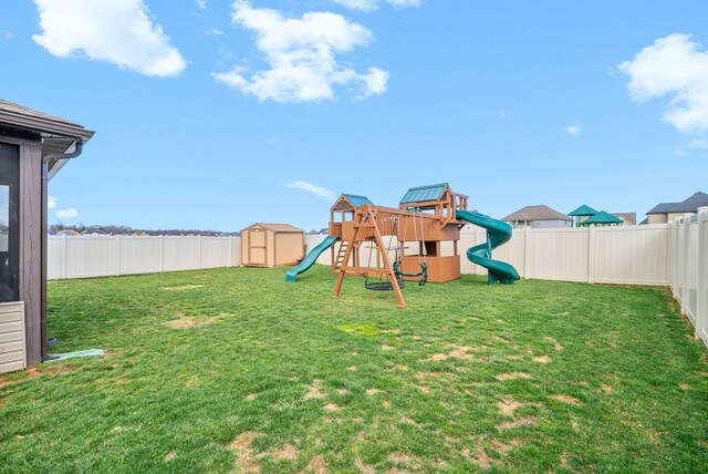 185 Kildeer Dr, Clarksville, TN 37040 - view of yard featuring a fenced backyard, a playground, an outbuilding, and a storage unit