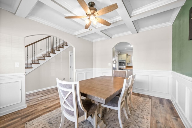 185 Kildeer Dr, Clarksville, TN 37040 - dining room featuring coffered ceiling, wood finished floors, beamed ceiling, arched walkways, and ceiling fan