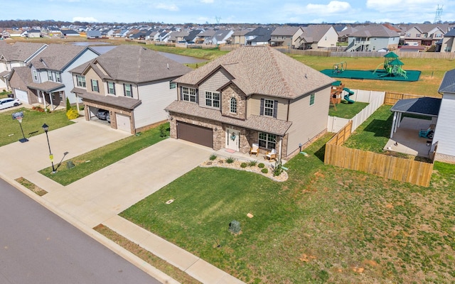 185 Kildeer Dr, Clarksville, TN 37040 - view of front of house featuring stone siding, concrete driveway, fence, an attached garage, and a residential view
