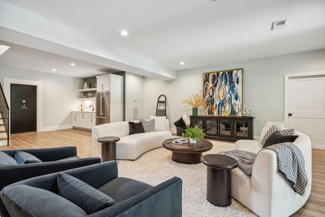 living area with stairs, visible vents, recessed lighting, and light wood finished floors