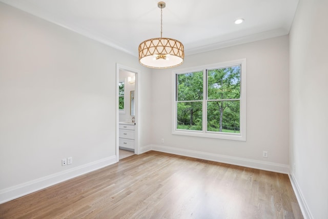 empty room featuring baseboards, light wood finished floors, and recessed lighting