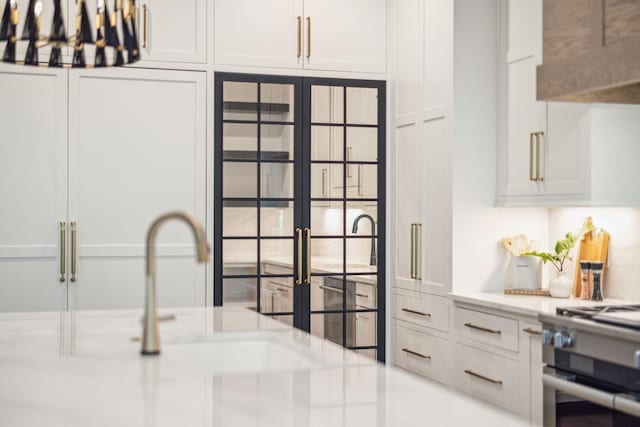 kitchen with white cabinetry, stainless steel gas stove, and french doors