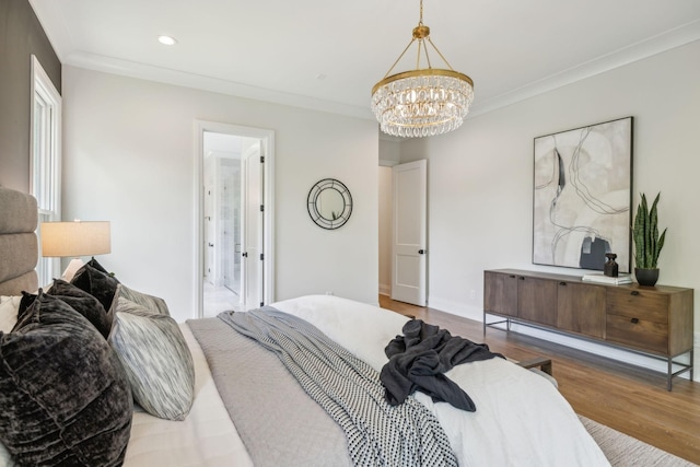 bedroom with crown molding, wood finished floors, recessed lighting, and a notable chandelier
