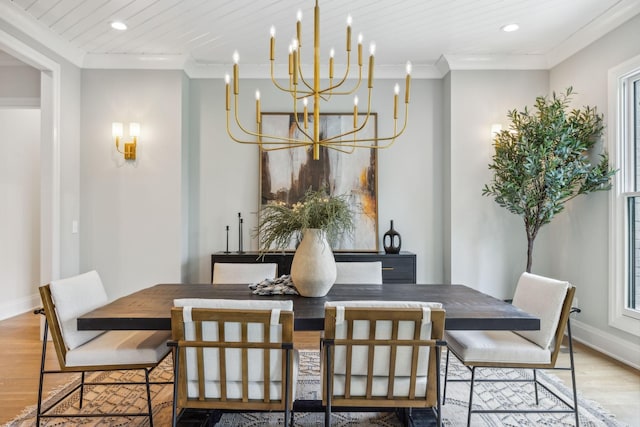 dining area featuring crown molding, recessed lighting, baseboards, a notable chandelier, and wood finished floors
