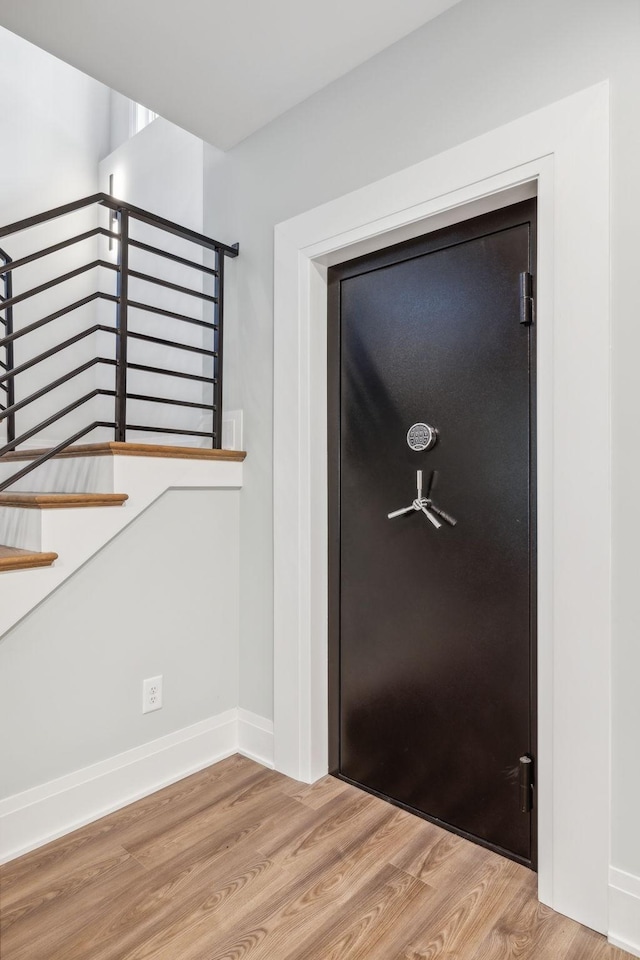 foyer featuring baseboards and wood finished floors