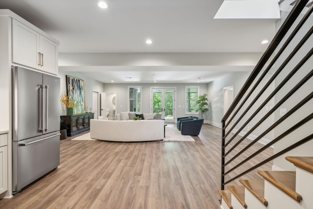 living room with stairway, light wood finished floors, and recessed lighting