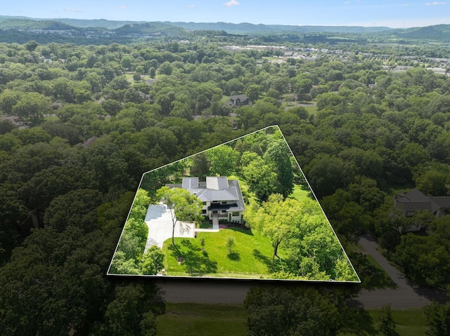 birds eye view of property with a view of trees
