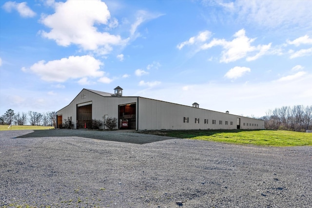 exterior space featuring a front lawn, an outdoor structure, an outbuilding, and a garage