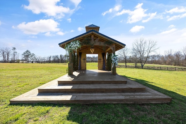 view of home's community with a gazebo, fence, and a lawn