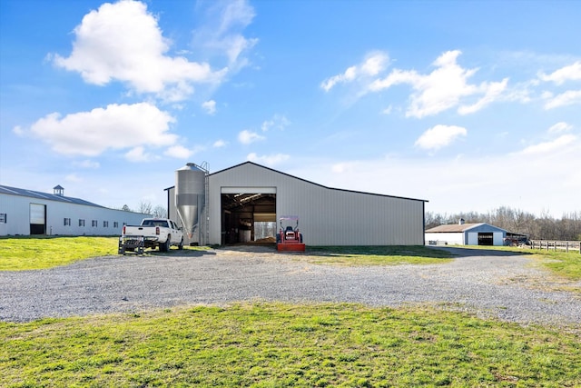 view of pole building with a yard