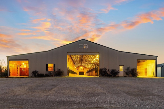 view of front of property with an outdoor structure, a garage, and a pole building