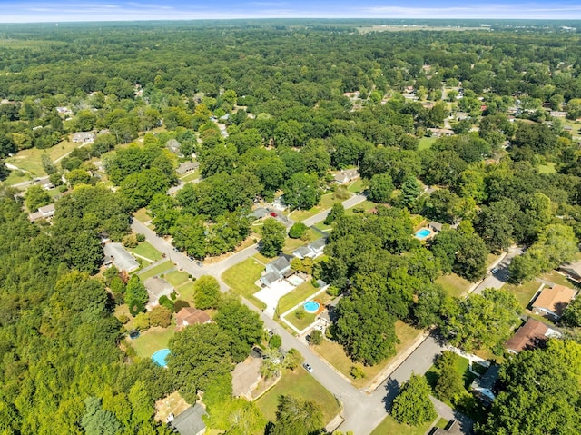 birds eye view of property with a wooded view