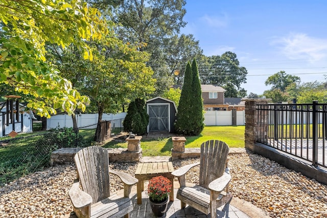 view of yard featuring a fenced backyard, an outbuilding, a shed, and a deck
