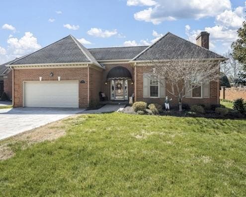 view of front of property with driveway, brick siding, a garage, and a front lawn