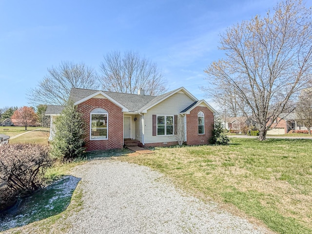 ranch-style home featuring brick siding, a shingled roof, a front lawn, and crawl space