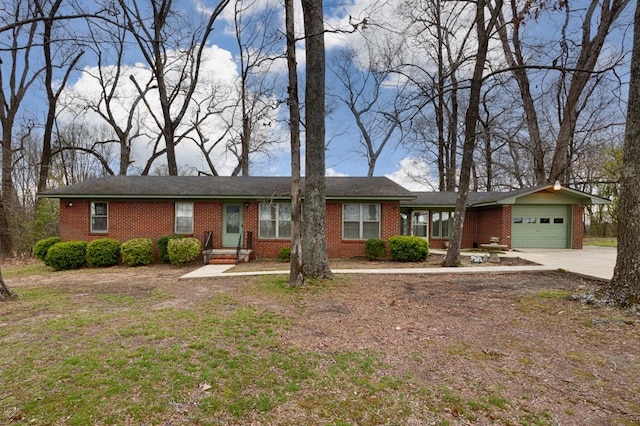single story home with brick siding, concrete driveway, and an attached garage
