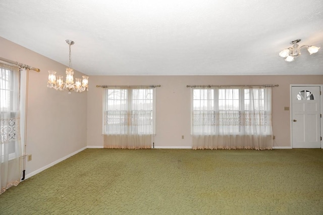 interior space with plenty of natural light, carpet flooring, and an inviting chandelier