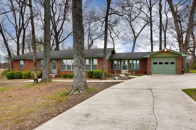 ranch-style house featuring brick siding, a garage, and concrete driveway