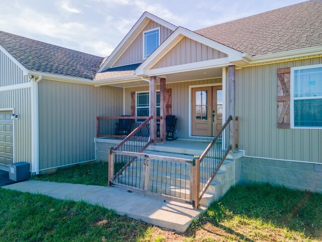 5113 Highland Lick Rd, Lewisburg, KY 42256 - view of exterior entry featuring a garage, a porch, and roof with shingles