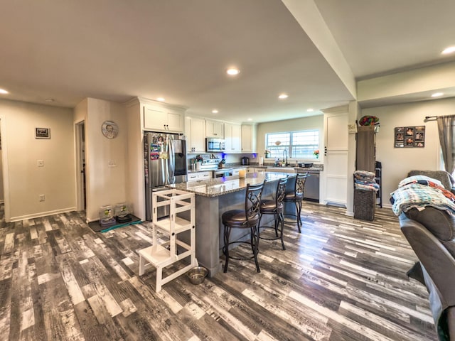 5113 Highland Lick Rd, Lewisburg, KY 42256 - kitchen featuring a sink, a kitchen breakfast bar, stainless steel appliances, white cabinets, and dark wood-type flooring