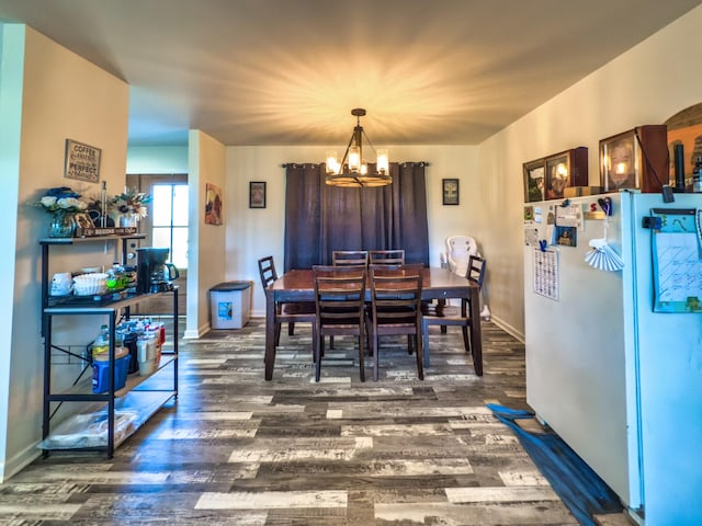 5113 Highland Lick Rd, Lewisburg, KY 42256 - dining space with baseboards, a notable chandelier, and wood finished floors