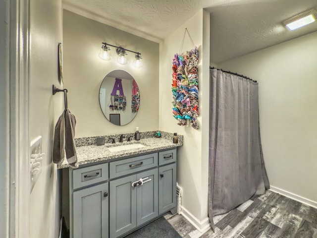 5113 Highland Lick Rd, Lewisburg, KY 42256 - full bath featuring a textured ceiling, a shower with shower curtain, baseboards, wood finished floors, and vanity
