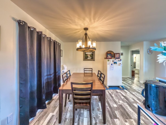 5113 Highland Lick Rd, Lewisburg, KY 42256 - dining space featuring baseboards, wood finished floors, and a chandelier