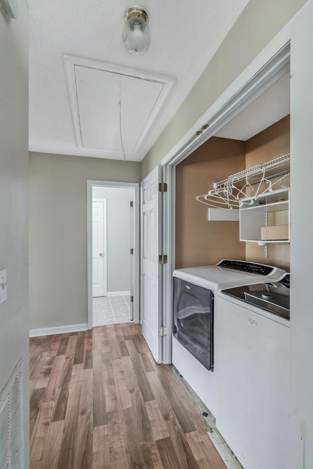 106 Hampton Dr, La Vergne, TN 37086 - laundry room featuring visible vents, wood finished floors, laundry area, attic access, and washing machine and dryer
