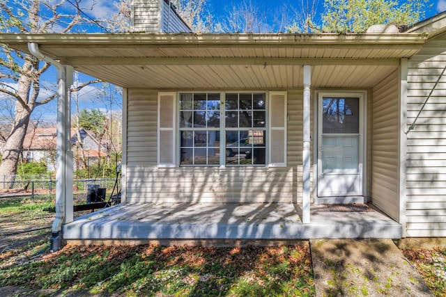 106 Hampton Dr, La Vergne, TN 37086 - view of exterior entry featuring a chimney, covered porch, and fence