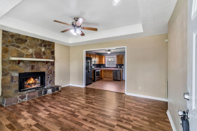 106 Hampton Dr, La Vergne, TN 37086 - unfurnished living room with a tray ceiling, baseboards, wood finished floors, and ceiling fan
