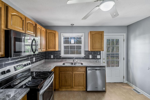 106 Hampton Dr, La Vergne, TN 37086 - kitchen with visible vents, a sink, stainless steel appliances, and brown cabinets