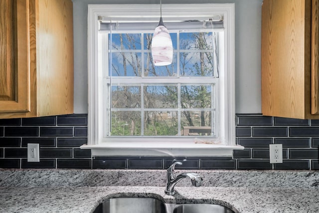 106 Hampton Dr, La Vergne, TN 37086 - kitchen featuring a sink, light stone counters, and decorative backsplash