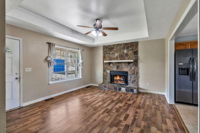 106 Hampton Dr, La Vergne, TN 37086 - unfurnished living room with a tray ceiling, visible vents, wood finished floors, and a ceiling fan