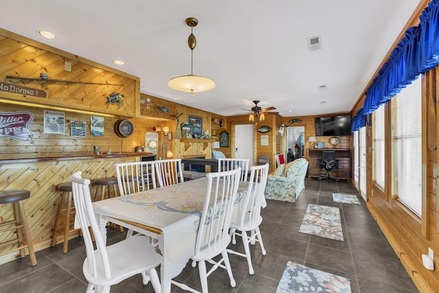 9395 Greenbriar Rd, Waverly, TN 37185 - dining space featuring wood walls, dark tile patterned floors, and ceiling fan