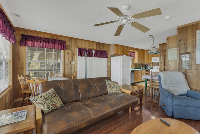 9395 Greenbriar Rd, Waverly, TN 37185 - living room with wood walls, a ceiling fan, and wood finished floors