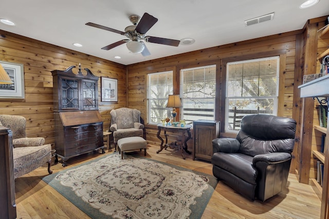 9395 Greenbriar Rd, Waverly, TN 37185 - sitting room with wooden walls, ceiling fan, recessed lighting, and light wood-style flooring