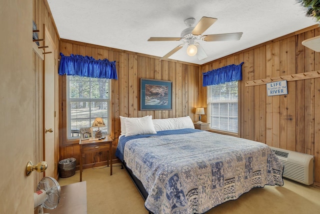 9395 Greenbriar Rd, Waverly, TN 37185 - bedroom featuring carpet floors, wooden walls, a textured ceiling, a ceiling fan, and a wall mounted air conditioner