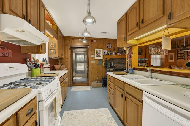 9395 Greenbriar Rd, Waverly, TN 37185 - kitchen featuring white appliances, under cabinet range hood, a sink, wood walls, and light countertops