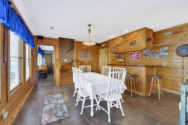 9395 Greenbriar Rd, Waverly, TN 37185 - dining space featuring wooden walls, stairs, and dark tile patterned flooring