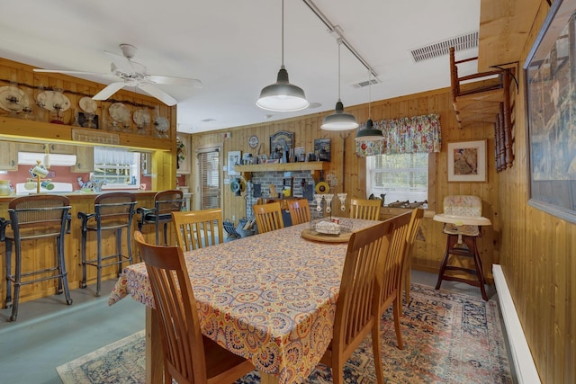 9395 Greenbriar Rd, Waverly, TN 37185 - dining room with wood walls, ceiling fan, and rail lighting