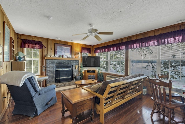 9395 Greenbriar Rd, Waverly, TN 37185 - living room featuring a textured ceiling, wood walls, wood-type flooring, a ceiling fan, and plenty of natural light