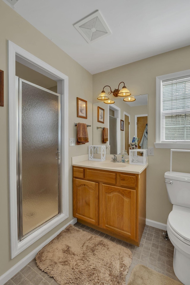 9395 Greenbriar Rd, Waverly, TN 37185 - bathroom featuring vanity, toilet, a stall shower, baseboards, and tile patterned flooring