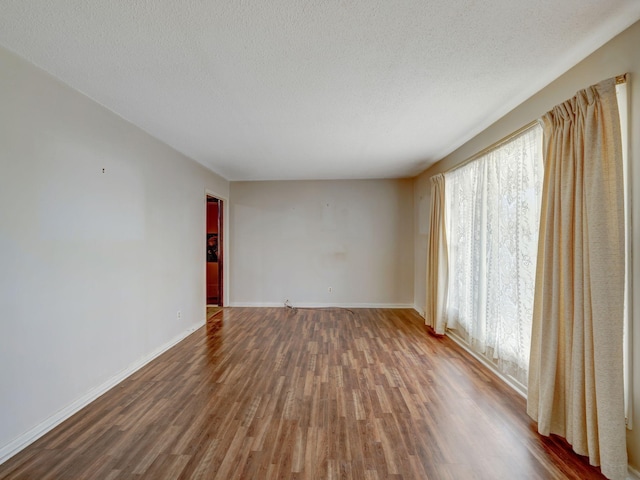 440 Appleton Dr, Clarksville, TN 37042 - empty room featuring a textured ceiling, baseboards, and wood finished floors