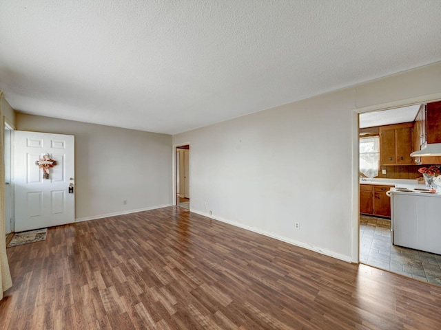 440 Appleton Dr, Clarksville, TN 37042 - unfurnished living room featuring dark wood-style flooring, baseboards, and a textured ceiling