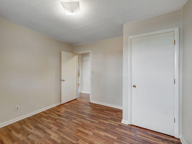 440 Appleton Dr, Clarksville, TN 37042 - unfurnished bedroom featuring baseboards, wood finished floors, and a textured ceiling