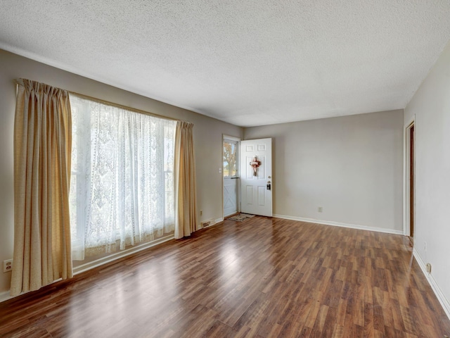 440 Appleton Dr, Clarksville, TN 37042 - unfurnished living room with baseboards, a textured ceiling, and dark wood-style flooring