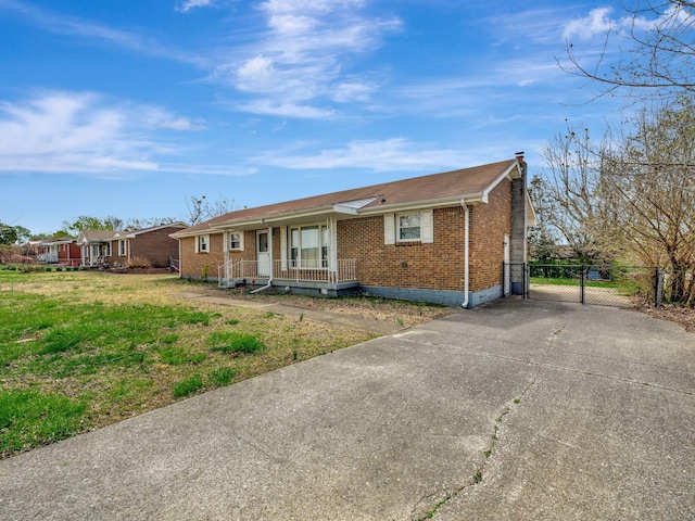 440 Appleton Dr, Clarksville, TN 37042 - ranch-style house with a gate, covered porch, concrete driveway, a chimney, and brick siding